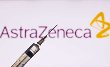 Kathmandu, Nepal - November 24 2020: Syringe Injection infront of AstraZeneca Logo. AstraZeneca...