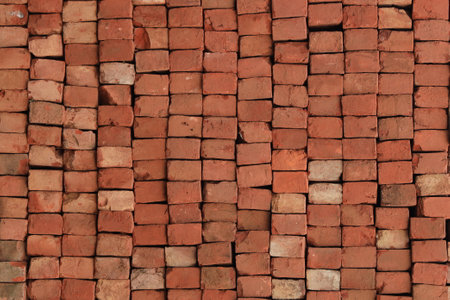 Brick Pattern. Stack of fresh processed bricks loosely stacked horizontally.