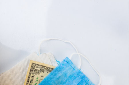 Coronavirus Relief Fund Concept. US Dollar placed on surgical mask with copyspace. Concept of Stimulus Bill or Stimulus check in United States.の写真素材