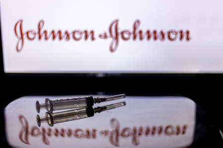Kathmandu, Nepal - February 7 2021: Syringe Injection placed against Johnson and Johnson logo. JnJ coronavirus vaccine will work with only 1 dose as compared to two doses required by other vaccines.のeditorial素材