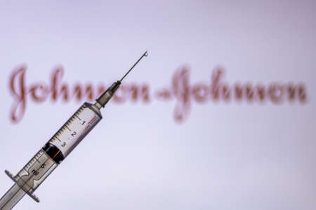 Kathmandu, Nepal - February 7 2021: Syringe Injection placed against Johnson and Johnson logo. JnJ coronavirus vaccine will work with only 1 dose as compared to two doses required by other vaccines.のeditorial素材