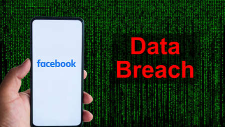 Facebook App aginst Leak text in red and Matrix-style green background. 533 Million Facebook User's personal information has been leaked online on Saturdayのeditorial素材