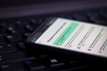 Kathmandu, Nepal - April 26 2021: WhatsApp Terms of Service on a smartphone against a PC computer.