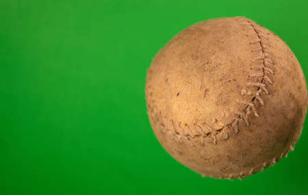 A close up of a old softball with a green screen.の写真素材