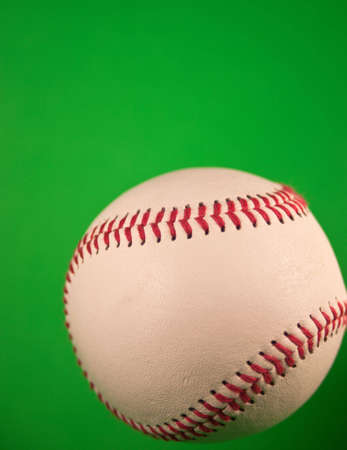 A close up of a new baseball with a green screen.の写真素材