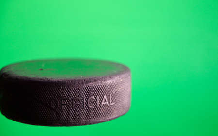 A close up of a old ice hockey puck with a green screen.の写真素材