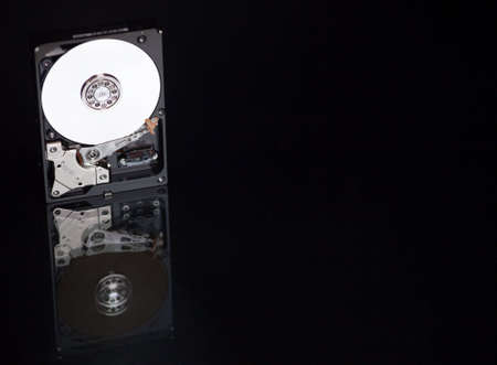 A close up of a computer hard drive with a black background.の写真素材