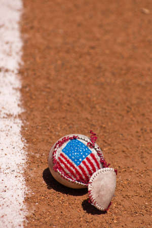 A close up of a torn baseball with a hand painted American Flag.の写真素材