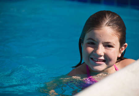 A close up of a young girl  poolside.の写真素材