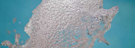 A close up of a water fountain with a blue background.
