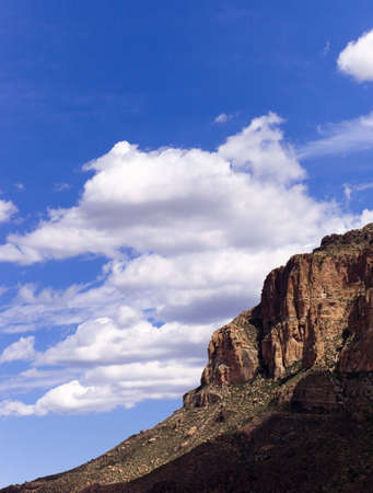 A shot of desert rock with a blue sky and clouds.の写真素材