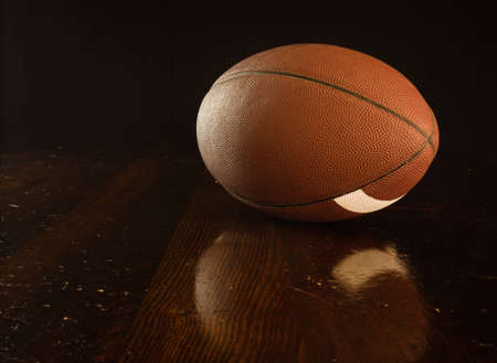 A close up of a footbal on a wood table.の写真素材
