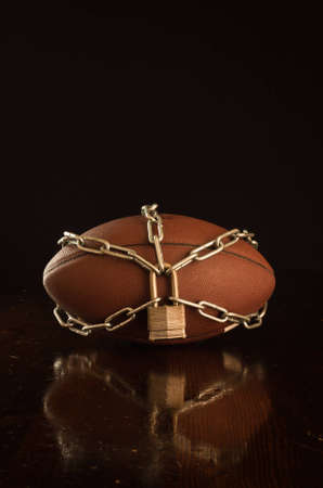 A close up of a football locked up with chain.