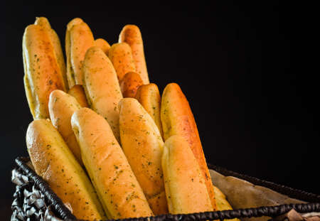 A close up of a bunch of freshly baked bread sticks.