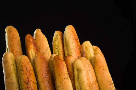 A close up of a bunch of freshly baked bread sticks.の写真素材