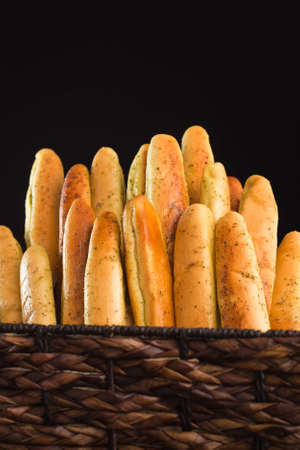 A close up of a bunch of freshly baked bread sticks.の写真素材