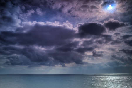 A wide shot looking out to the Pacific Ocean from the south side of the Huntington Beach Pier on a...