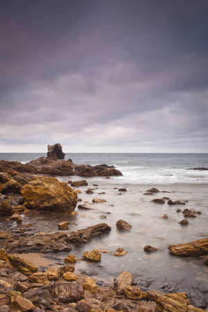 A shot of an early morning Corona Beach in Newport Beach California with the surf crashing into...