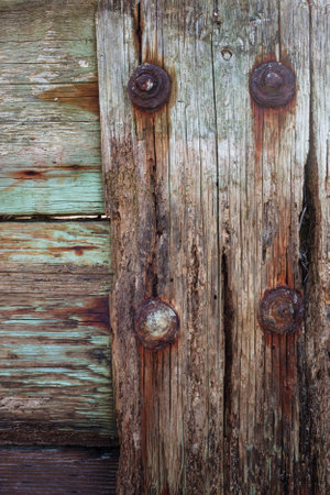 A close up of an old beach retaining wall with rusted out nuts and bolts.の写真素材