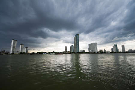 Modern Building on Chaopraya Riverside With Storm Clouds Sky の写真素材