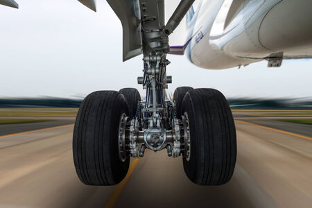 Airplane wheel in a landing gear with motion blurの写真素材