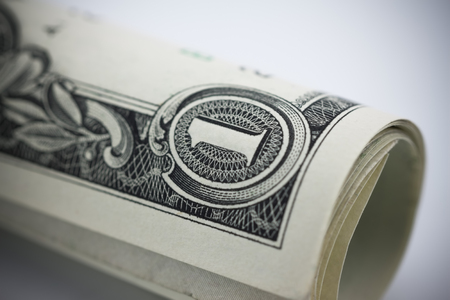 closeup roll of one dollar banknotes