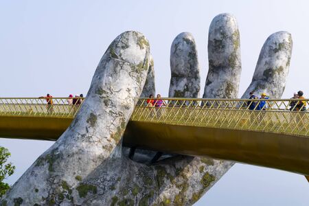 Da Nang, Vietnam - Mar. 29, 2019: The Golden Bridge. The two giant colossal hands emerging from the mountains holding up the golden bridge at the height of 1,414 m from the sea level in Ba Na Hills.のeditorial素材