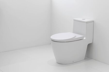White flush toilet in white bathroom.の写真素材