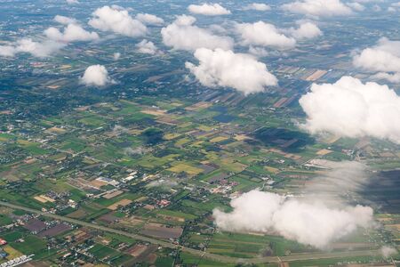 Aerial view rice fields from airplane window before landing to Donmueang Airport, Bangkok Thailand.