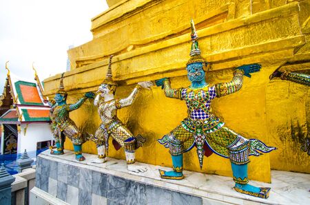 The thai giant statue in action to lifting gold pagodaの写真素材