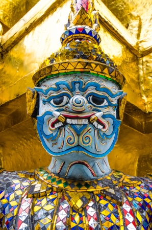 The thai giant statue in action to lifting gold pagodaの写真素材