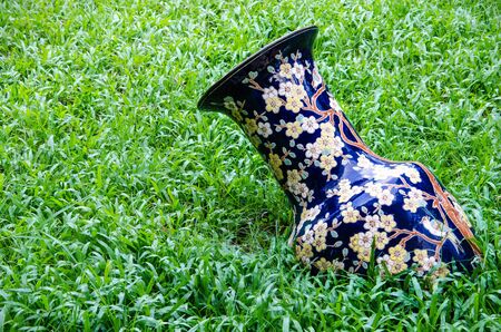 Big blue chinese bottle with green grass.の写真素材