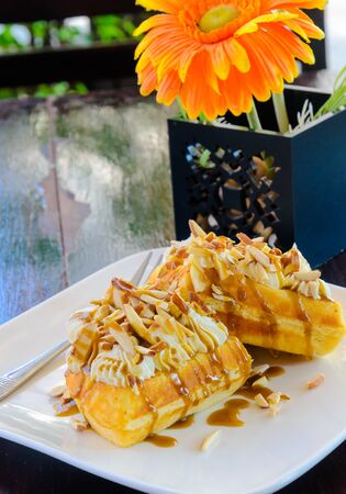 Caramel waffle on the wood table.の写真素材