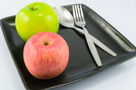 Apple on dish with white backgrounds.の写真素材