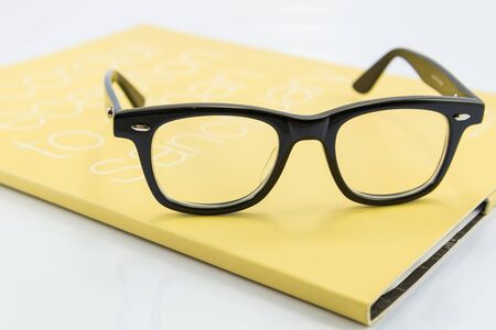 Glasses on the bookの写真素材