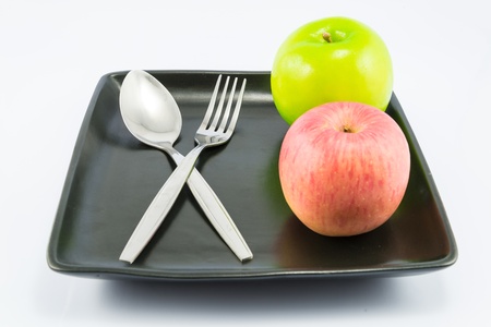Apple on dish with white backgrounds.の写真素材