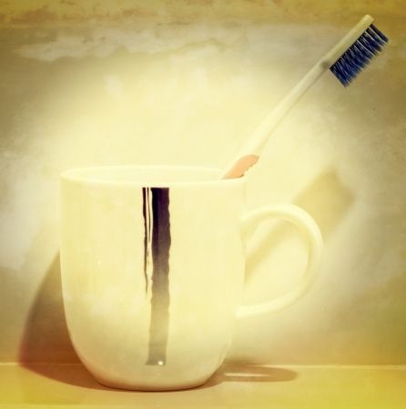 Tooth brush in a cup (Process in old vintage style)の写真素材