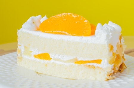 Orange Cake in white dish on the wood tableの写真素材