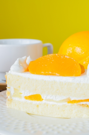 Orange Cake in white dish on the wood tableの写真素材