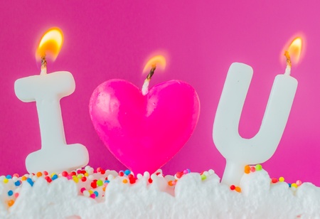 Candle on rainbow cakeの写真素材