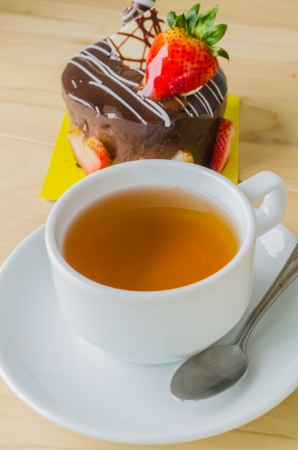 white tea cup with chocolate cakeの写真素材