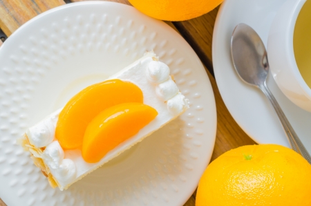 Orange Cake in white dish on the wood tableの写真素材