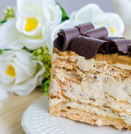 Coffee cake in white dish on the wood tableの写真素材