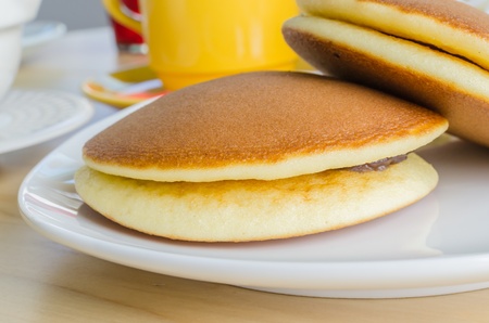 Pancake in white dish on the wood tableの写真素材