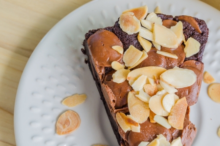 Brownie cake on white dish with almond&chocolate chipの写真素材