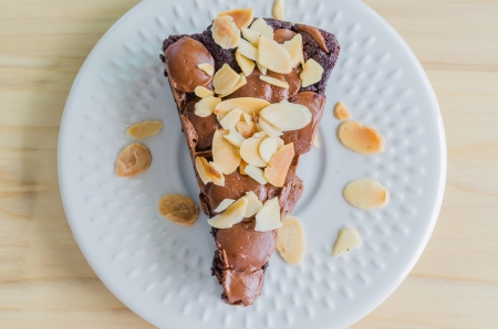Brownie cake on white dish with almond&chocolate chipの写真素材