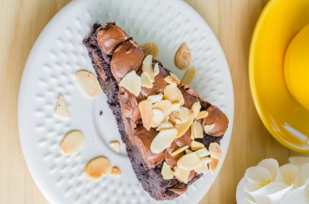 Brownie cake on white dish with almond&chocolate chipの写真素材