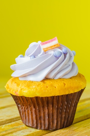 Cupcake on the wood table with color backgroundの写真素材