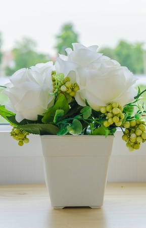 Beautiful fake flower on the wood tableの写真素材
