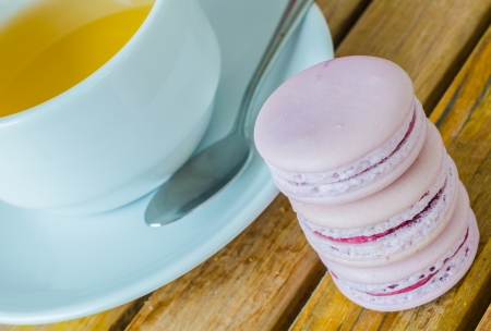 Grape macaroon on the wood table with white tea cupの写真素材